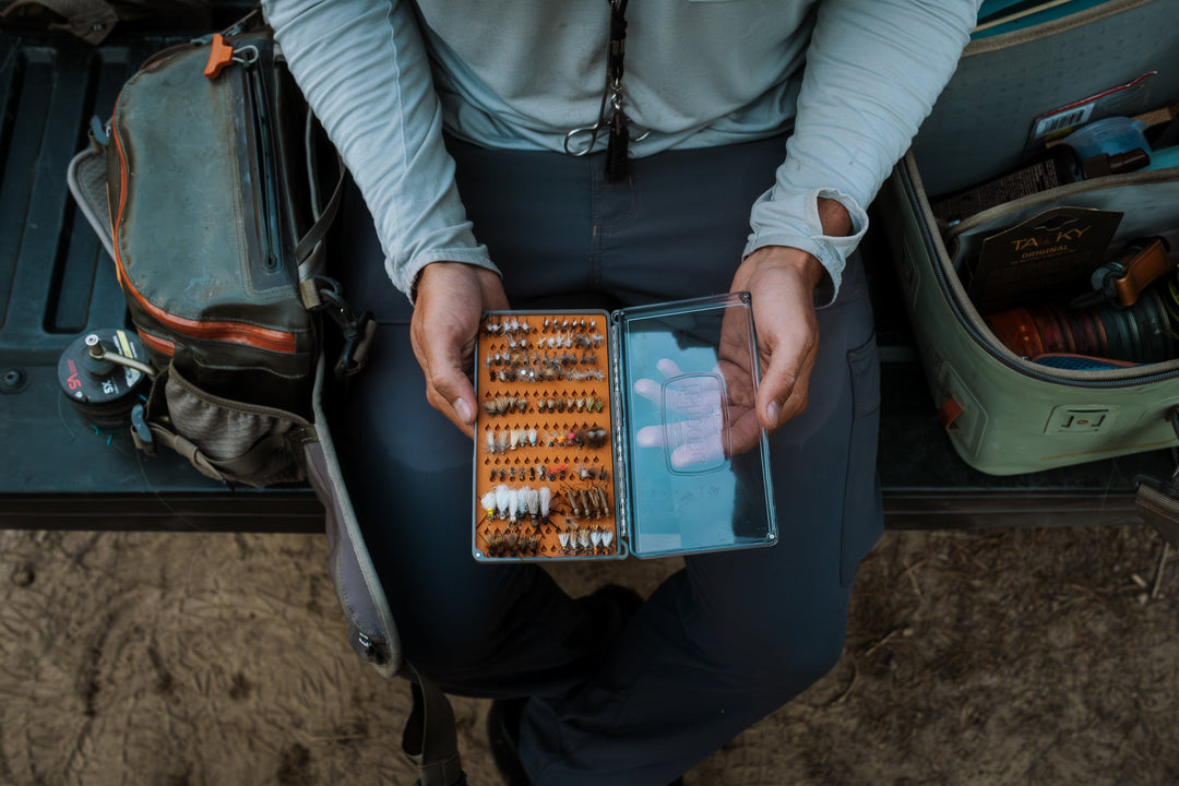 Angler using the Fishpond Tacky Original Fly Box Burnt Orange