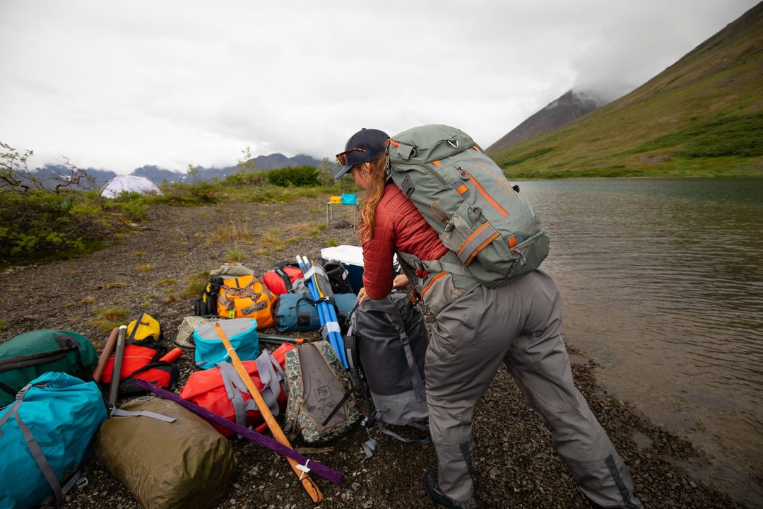 Angler wearing the Fishpond Firehole Backpack in Alaska