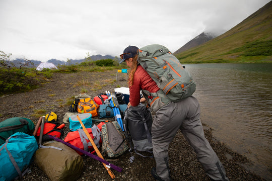 Angler wearing the Fishpond Firehole Backpack in Alaska